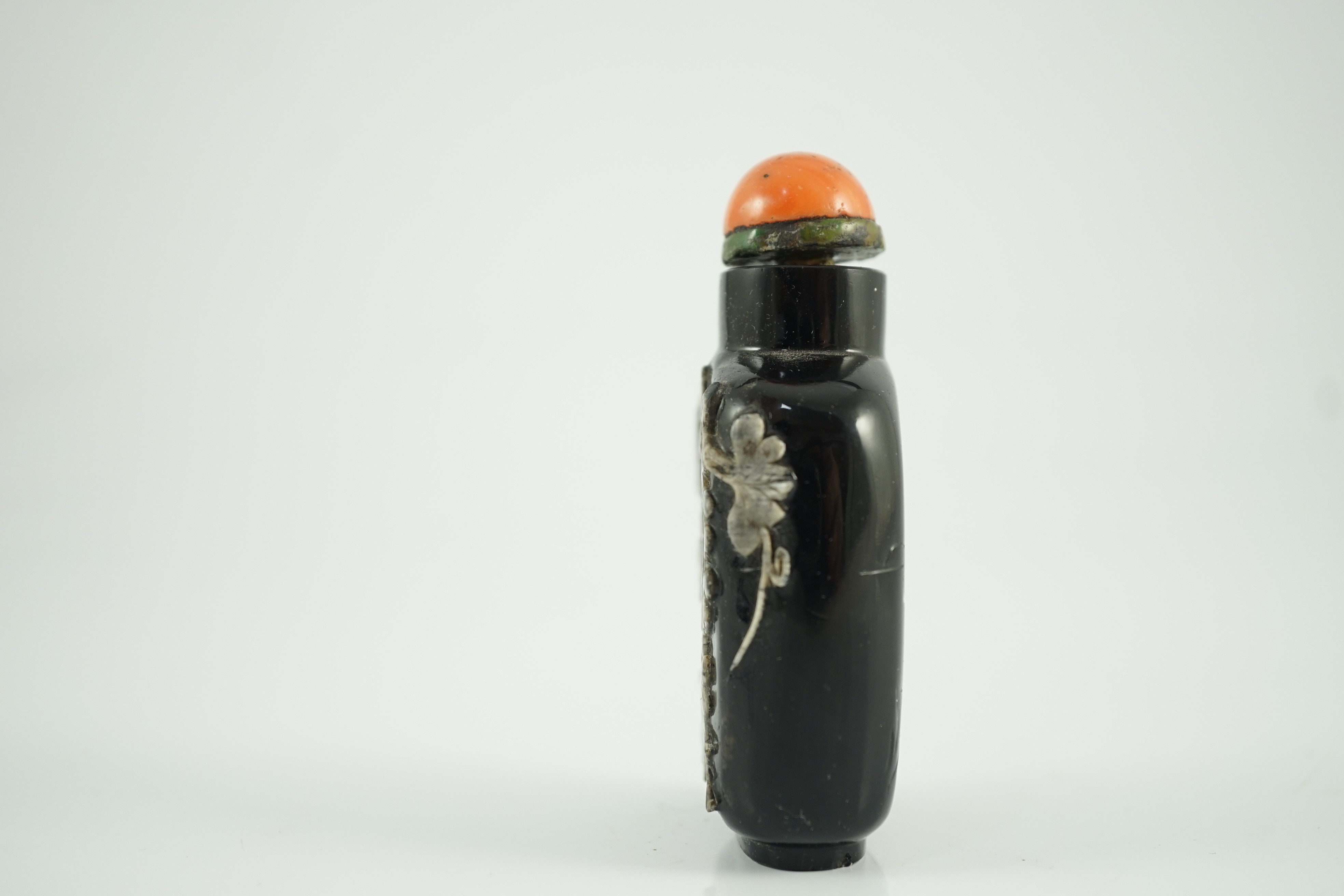 A Chinese smoky quartz snuff bottle, 1780-1820, 6.7cm high, coral stopper